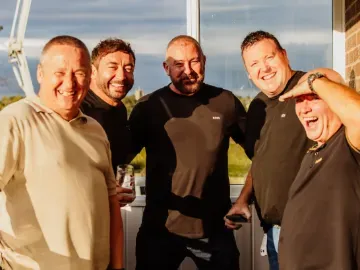 A group of Gents enjoying the hospitality balcony at Sedgefield Racecourse in the sunshine