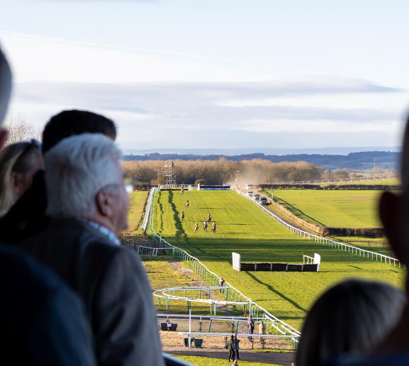 Hospitality guests look out from the balcony at the race below at Sedgefield