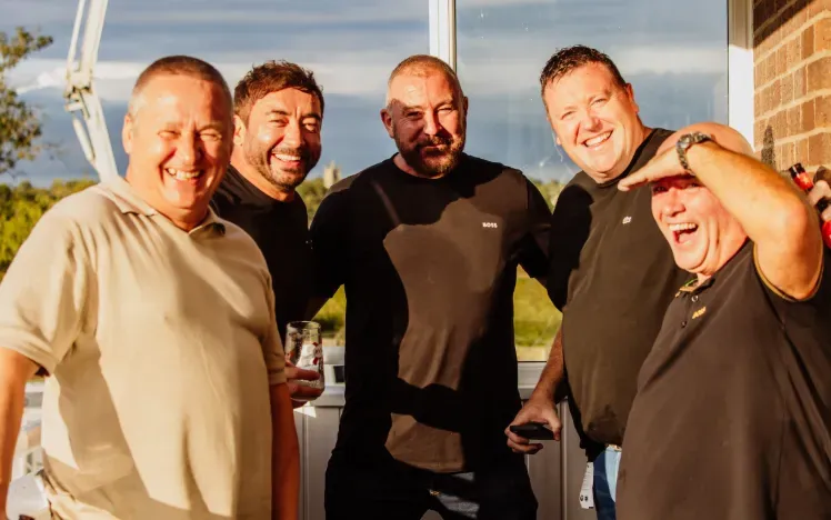 A group of Gents enjoying the hospitality balcony at Sedgefield Racecourse in the sunshine