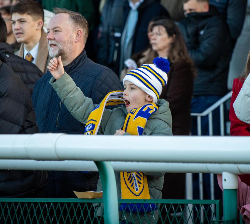 A young boy cheers excitedly for the races at Sedgefield