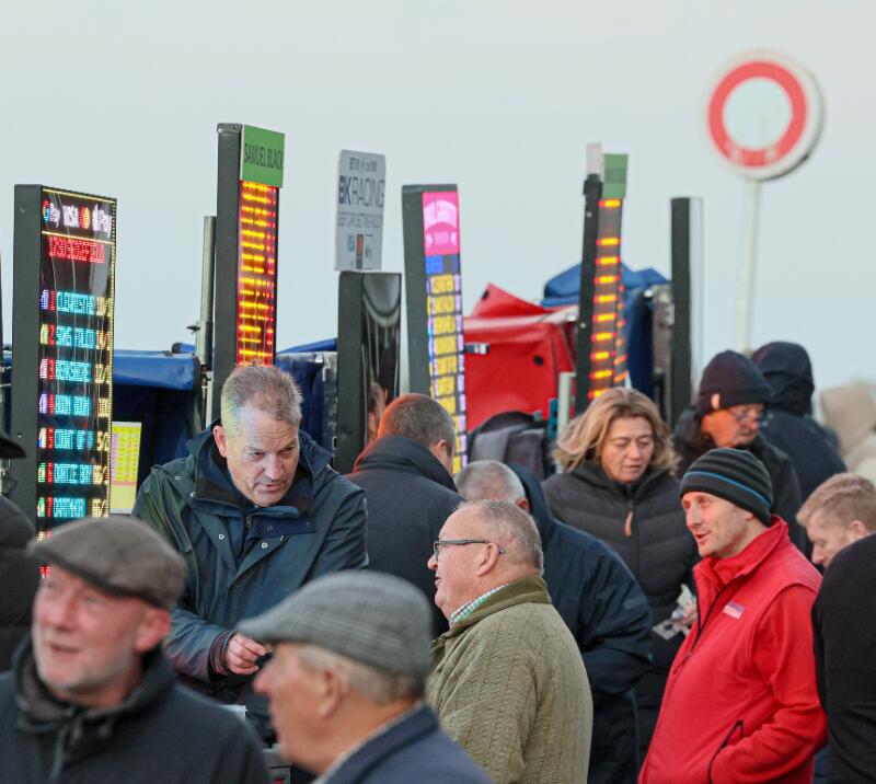 A close up of race goers placing a bet with a bookmaker at Sedgefield