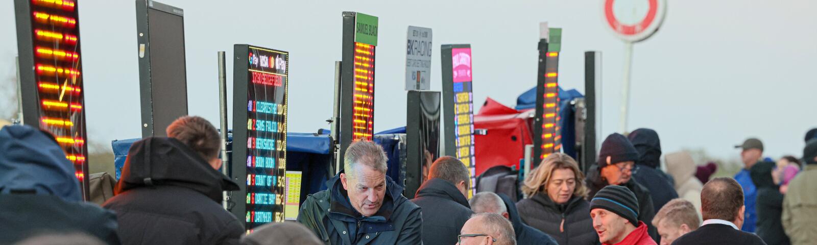 A close up of race goers placing a bet with a bookmaker at Sedgefield