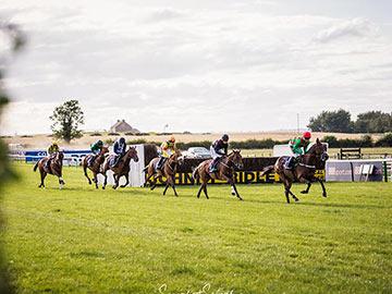 Group of jockeys racing at Sedgefield Racecourse.