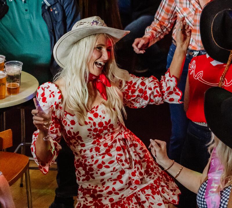 Racegoers dressed up for a cowboy event dance to the live music at Sedgefield