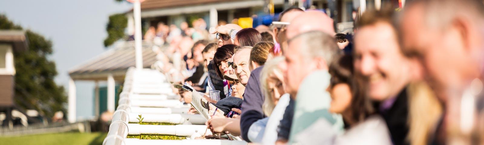 Racegoers lined up next to the track at Sedgefield Racecourse.