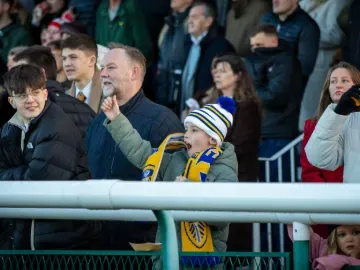 A young boy in the crowd at Sedgefield cheers the race